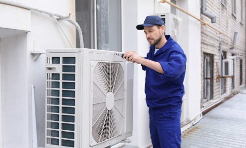 Professional technician installing a new air conditioning unit