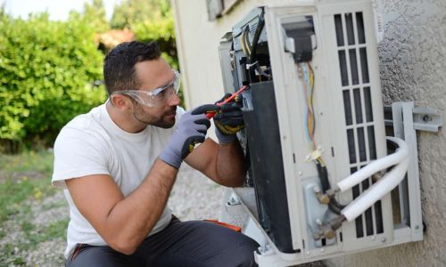 Skilled technician repairing air conditioning unit